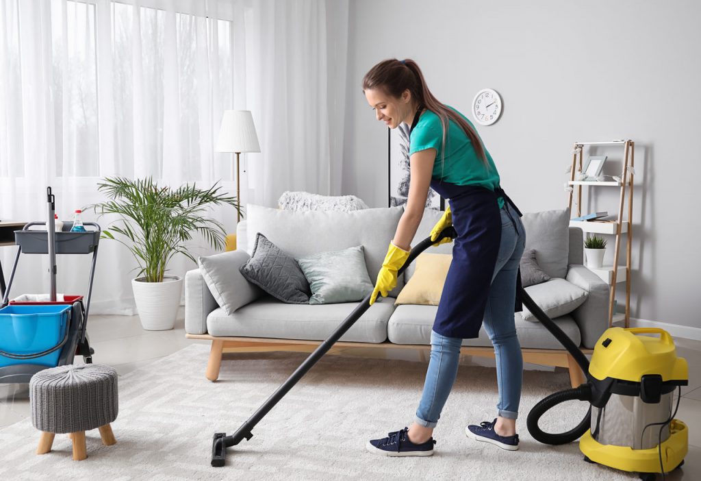 lady hoovering a living room
